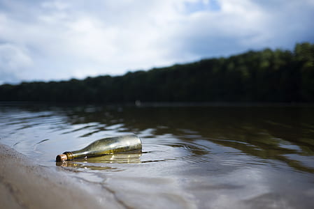 clear glass bottle on water under clear sky thumbnail