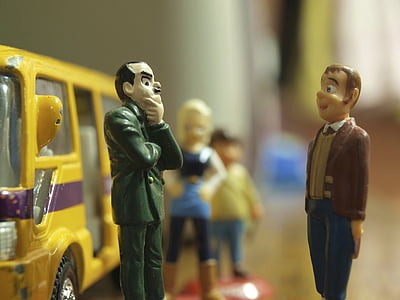 man in green top in front man in brown top figurines thumbnail