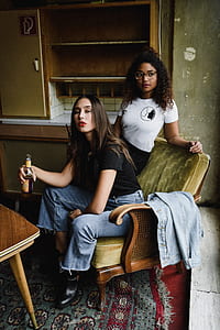 two women sitting on armchair thumbnail