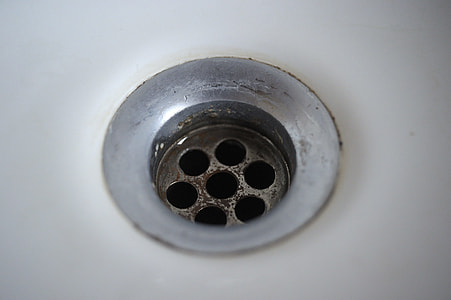 selective focus photography of round gray metal drain thumbnail