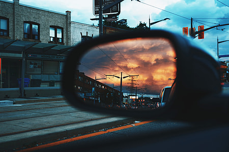 photography of car wing mirror during sunset thumbnail