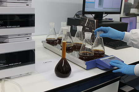 Erlenmeyer flasks on table near monitor thumbnail