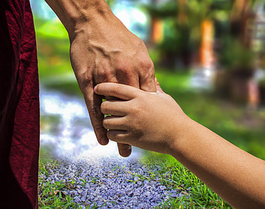 adult hand holding child's hand bokeh photo thumbnail