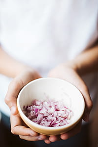 person holding bowl of slice onions thumbnail