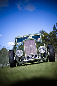 classic green car on green field selective focus photography thumbnail