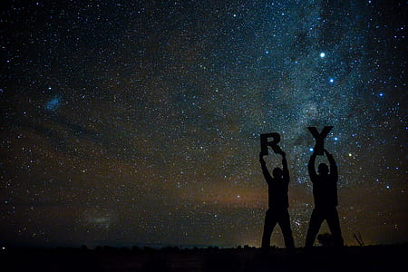 silhouette photo of men holding letters thumbnail
