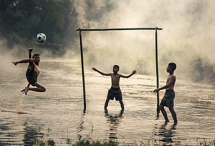 three boys playing soccer thumbnail