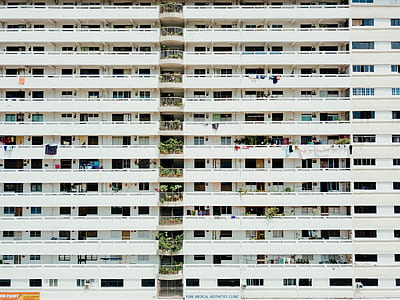 concrete buildings with balconies during day thumbnail