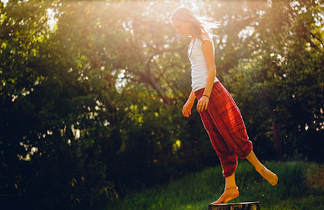 woman wearing white tank top and red pants outfit thumbnail