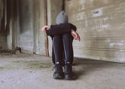 person wearing black tracksuit lying on ground thumbnail