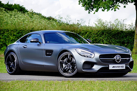 silver Mercedes AMG GT beside green grass thumbnail