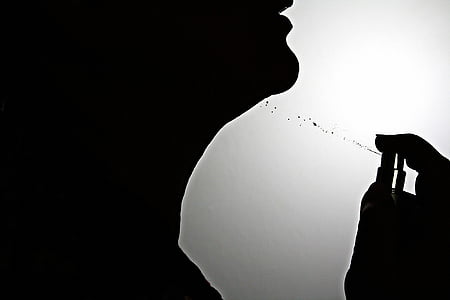 silhouette of person using spray bottle thumbnail