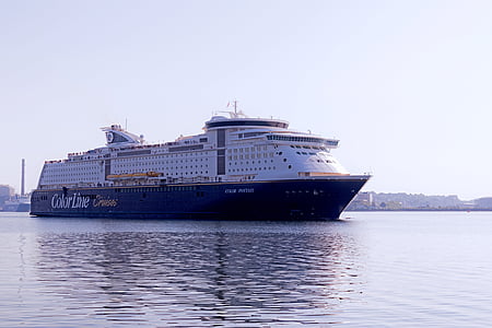 blue and white cruise ship under white sky during daytime thumbnail