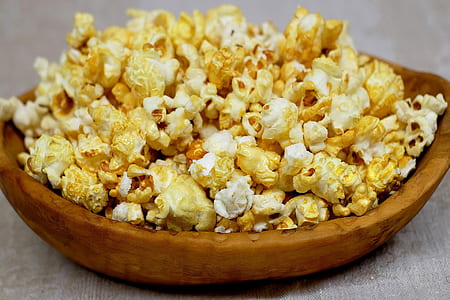 popcorn on brown wooden bowl thumbnail