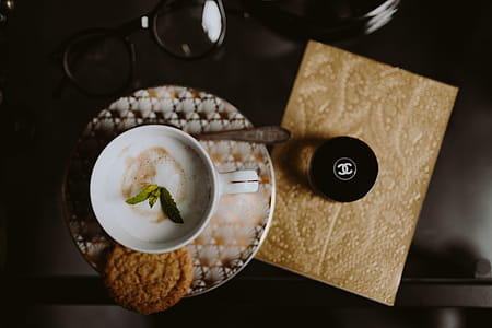 Coffee in a decorative cup with a golden ornament thumbnail