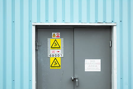 gray metal door with assorted signages thumbnail
