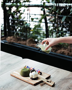person holding clear glass bottle thumbnail