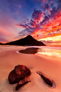shore near silhouette of mountain at golden hour thumbnail