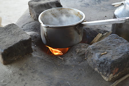 stainless steel pot with handle on top of flame thumbnail