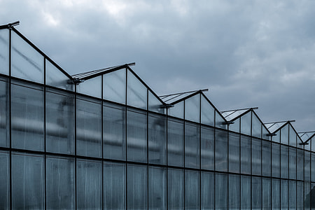 gray concrete building under cloudy sky thumbnail