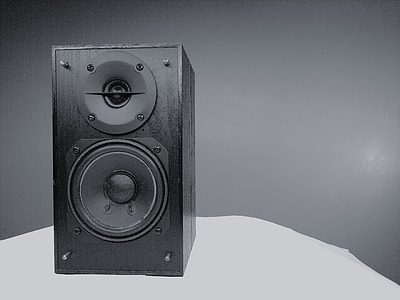 black bookshelf speaker on white desk thumbnail