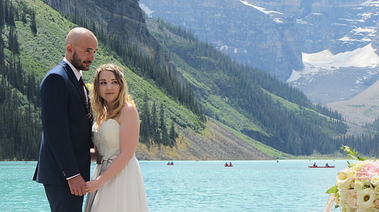 couple standing near body of water at daytime thumbnail