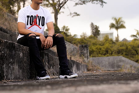 man sitting on concrete bench at daytime thumbnail