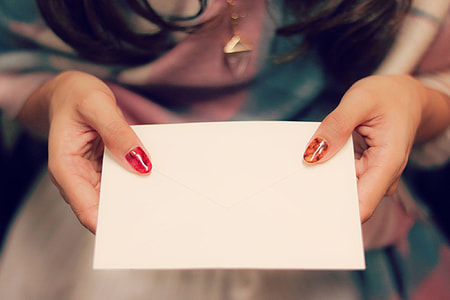 woman holding white paper thumbnail