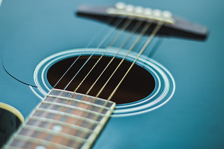 shallow focus photography of blue acoustic guitar thumbnail