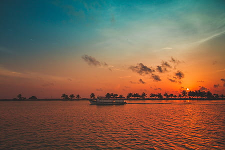 boat at the bod of water during sunset thumbnail