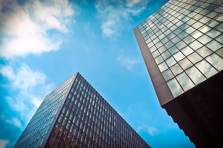low-angle photography of gray building under white sky thumbnail