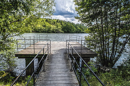 brown and black dock near body of water thumbnail