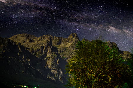 gray mountains under starry sky during nighttime thumbnail