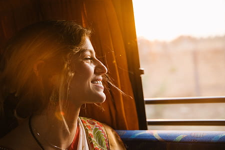woman sitting near window during daytime photo thumbnail