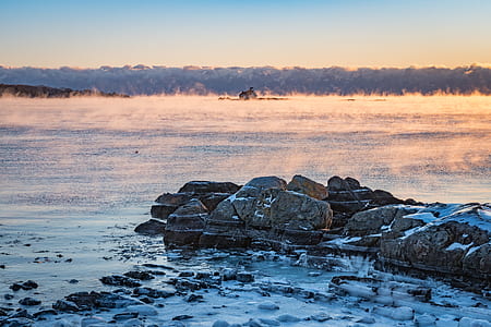 gray stones beside seashore thumbnail