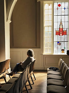 woman on chair beside window thumbnail
