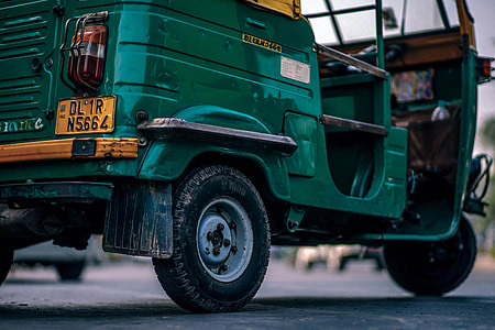 closeup photo of green and yellow auto rickshaw thumbnail