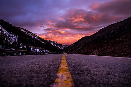 narrow road surrounded with mountains thumbnail