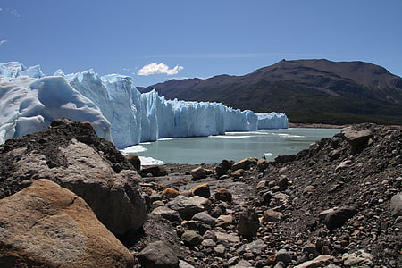 iceberg beside body of water and mountains during daytime thumbnail