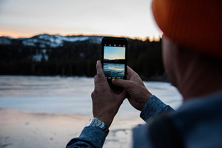 man taking photo of the mountain thumbnail