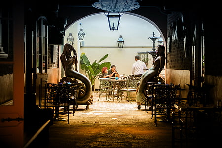 two mermaids sitting on chairs near dining set thumbnail