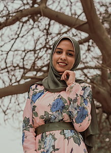Woman in Floral Abaya Standing Near Tree thumbnail