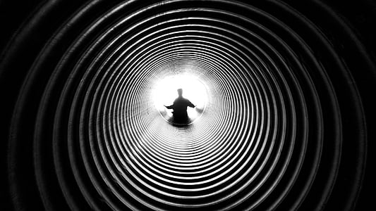 grayscale photography of man standing at the top of well thumbnail