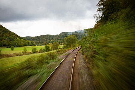 panning photography of brown train rail thumbnail