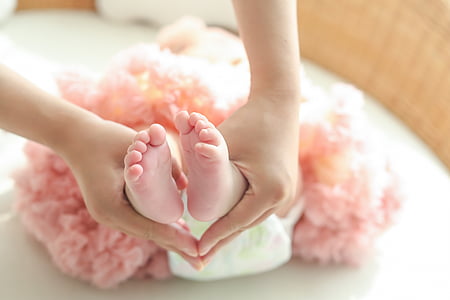 person holding baby foots selective focus photography thumbnail