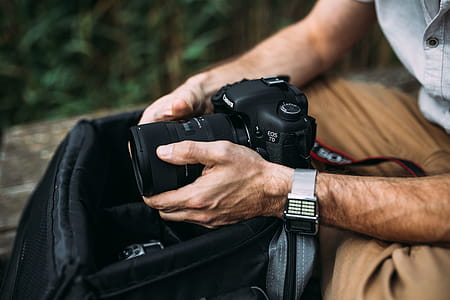 Photographer holding a DSLR camera thumbnail