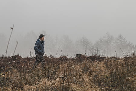 Man Walking on Grass Field thumbnail