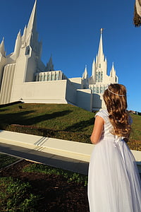 woman stand near white church thumbnail