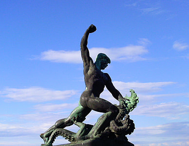 man raising right hand statue under blue sky thumbnail