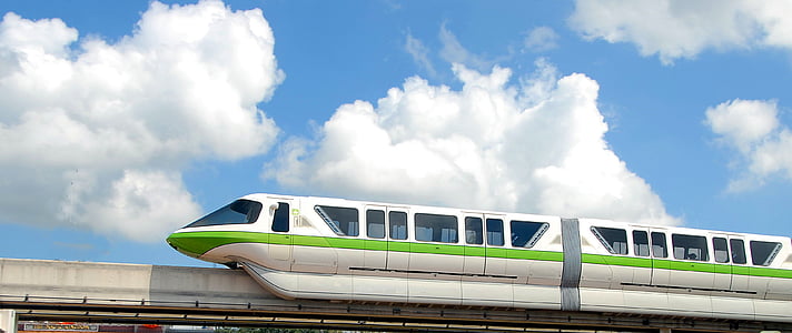 white and green train under cloudy sky at daytime thumbnail